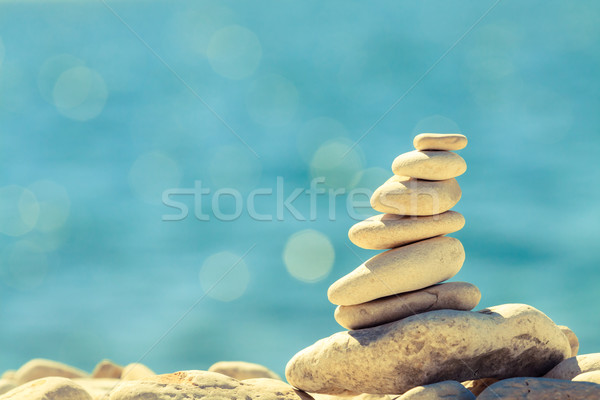 Stones balance at the beach, stack over blue sea Stock photo © blasbike