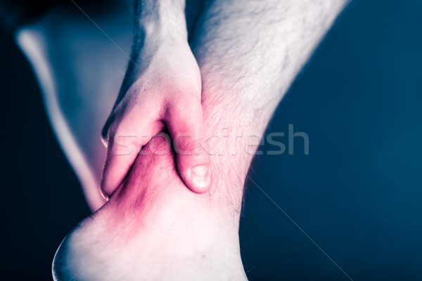 Ankle pain, physical injury painful leg Stock photo © blasbike