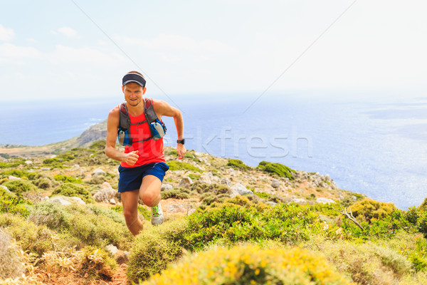 Stock photo: Happy trail running man in beautiful mountains