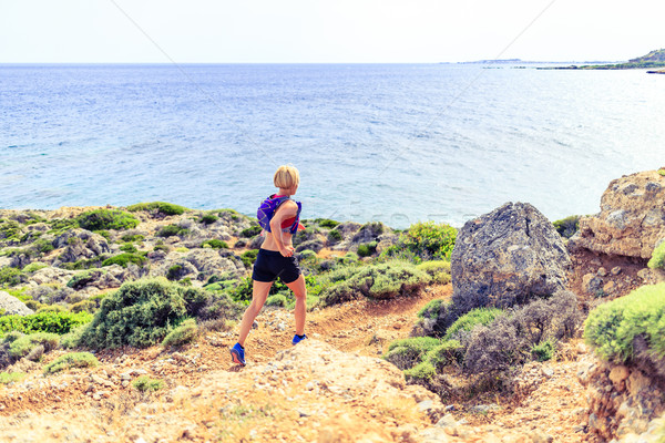 Happy woman trail running in beautiful mountains Stock photo © blasbike