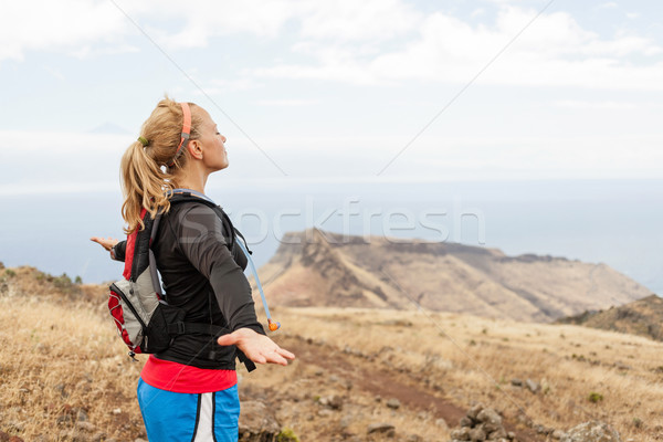 Woman runner, arms outstreched in mountains Stock photo © blasbike
