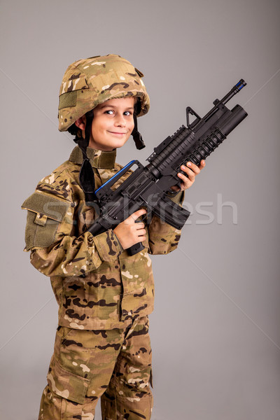 Young boy dressed like a soldier with rifle Stock photo © bloodua
