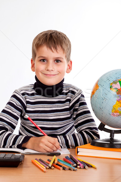 Cute schoolboy is writting Stock photo © bloodua