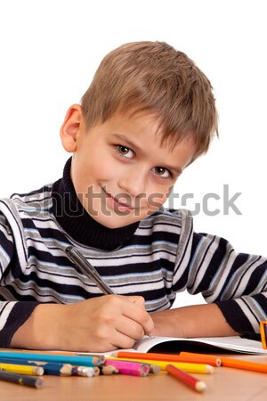 Cute schoolboy is writting Stock photo © bloodua