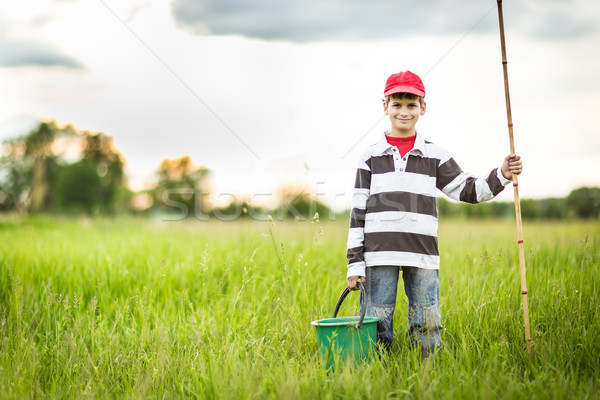 Stock photo: Young boy fishing in a river