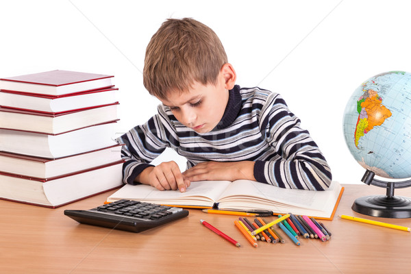 Cute schoolboy is writting Stock photo © bloodua