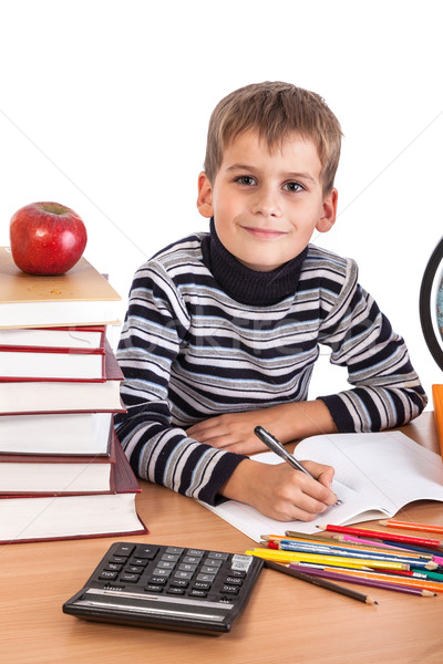 Cute schoolboy is writting Stock photo © bloodua