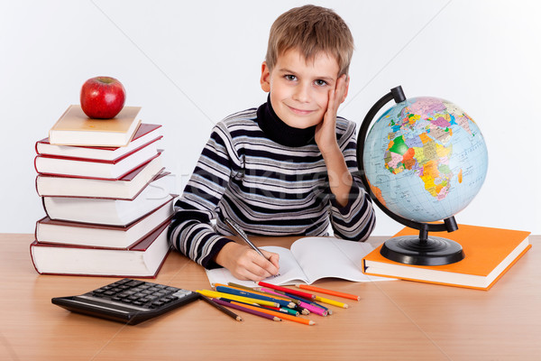 Cute schoolboy is writting Stock photo © bloodua