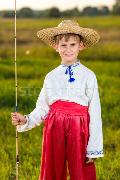 Photo of little kid pulling rod while fishing on weekend Stock photo © bloodua