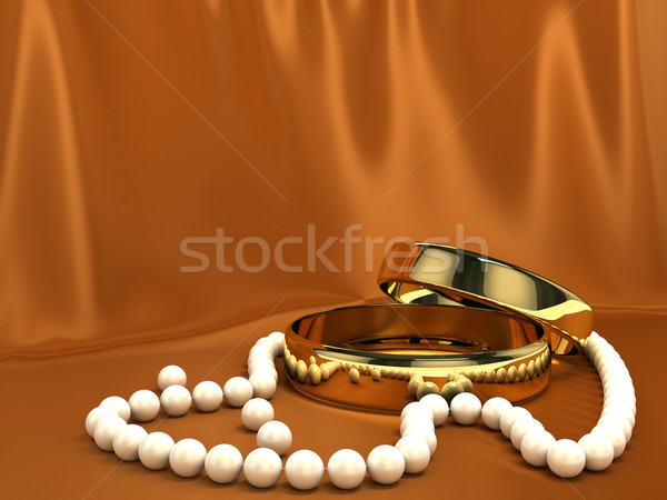 Two gold rings on red silk Stock photo © blotty