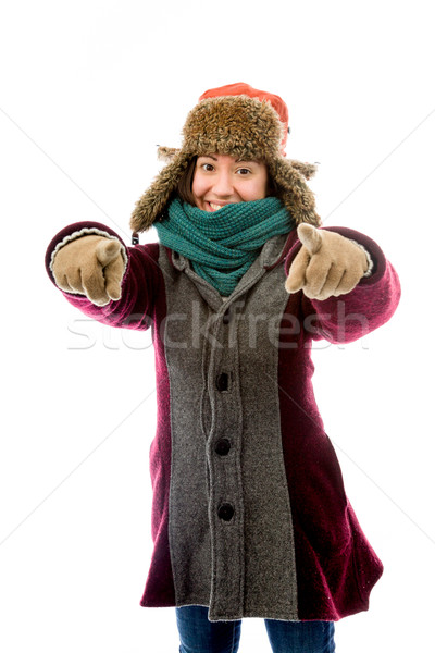 Young woman in warm clothing and pointing towards camera with bo Stock photo © bmonteny