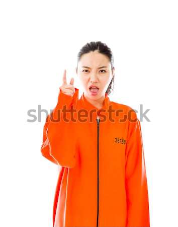 Young Asian woman showing thumb up sign in prisoners uniform Stock photo © bmonteny