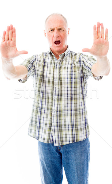 Senior man stopping with hand gesture Stock photo © bmonteny