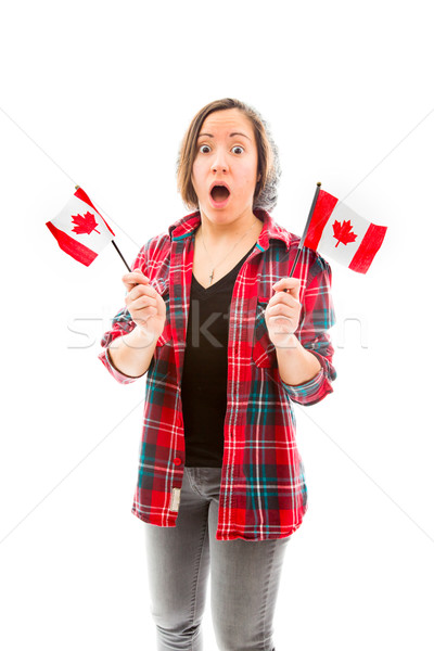 Young woman looking shocked with holding Canada flag Stock photo © bmonteny