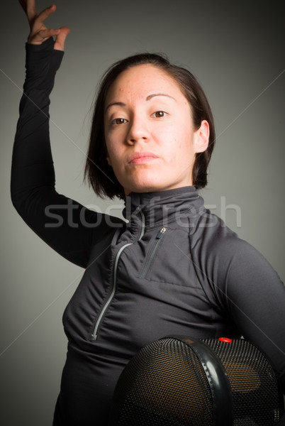 Portrait of a female fencer wearing fencing uniform and holding Stock photo © bmonteny