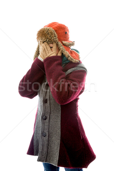 Young woman in warm clothing and peeking through her fingers Stock photo © bmonteny