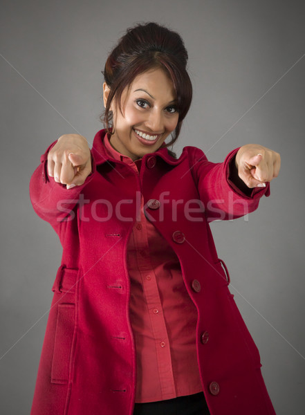 Smiling Indian young woman pointing towards camera from both hands Stock photo © bmonteny