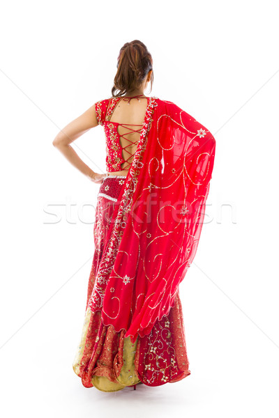 Rear view of a young Indian woman standing with her arms akimbo Stock photo © bmonteny