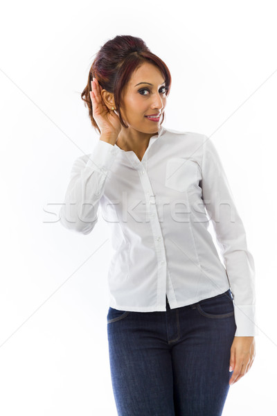 Stock photo: Indian young woman with hand to ear listening isolated over white background