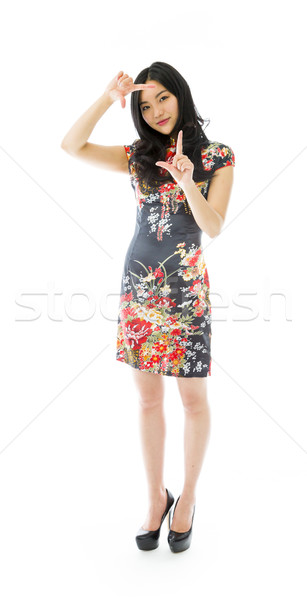 Asian young woman looking through finger frame Stock photo © bmonteny