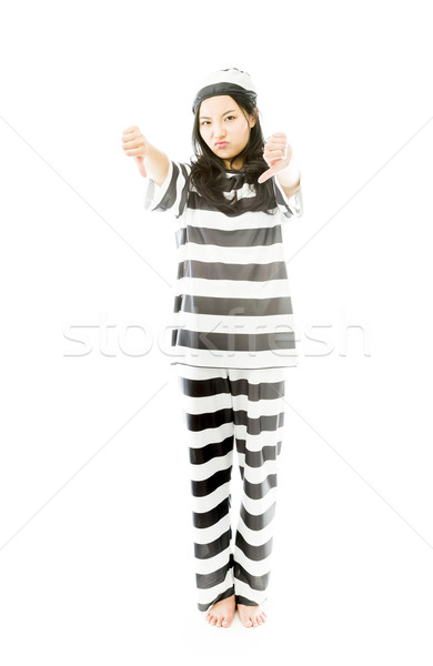 Young Asian woman showing thumbs down sign from both hands in prisoners uniform Stock photo © bmonteny