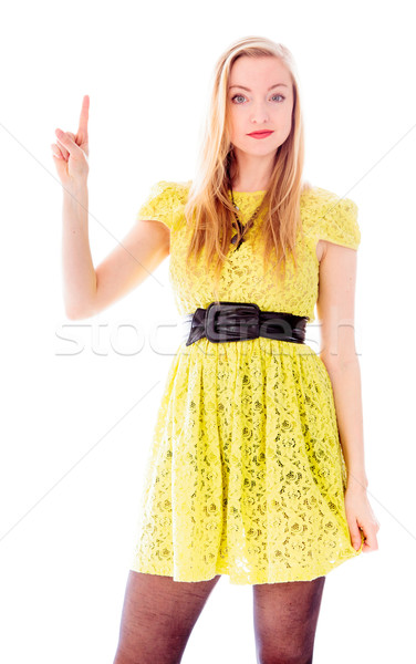 Beautiful young woman standing and pointing upward Stock photo © bmonteny