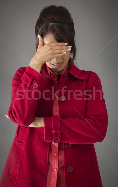 Upset Indian young woman with her head in hands on colored background Stock photo © bmonteny