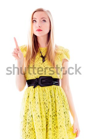 Beautiful young woman standing and pointing upward Stock photo © bmonteny