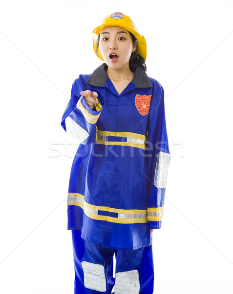 Shocked lady firefighter with pointing isolated on white background Stock photo © bmonteny