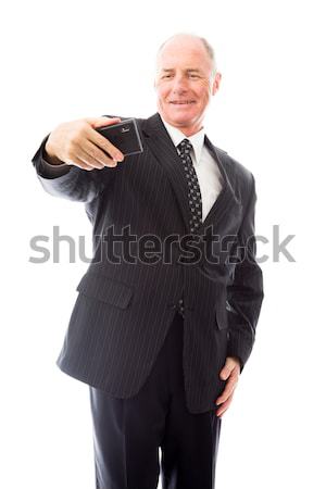 Businessman photographing self with a mobile phone Stock photo © bmonteny