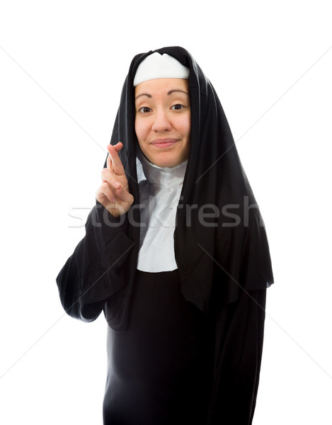 Young nun wishing with crossing fingers Stock photo © bmonteny