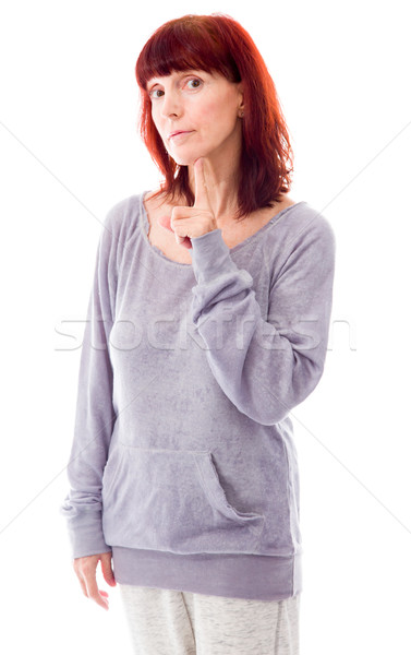 Mature woman standing with her hand on chin Stock photo © bmonteny