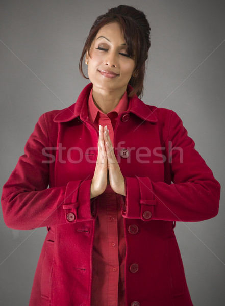 Indian young woman standing in prayer position Stock photo © bmonteny