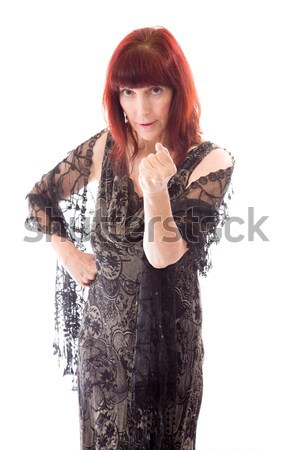 Mature woman standing with her hand on chin Stock photo © bmonteny