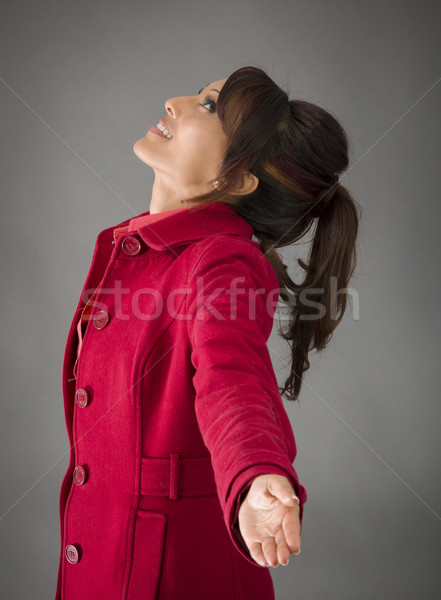 Side profile of an Indian young woman with arms outstretched and day dreaming Stock photo © bmonteny
