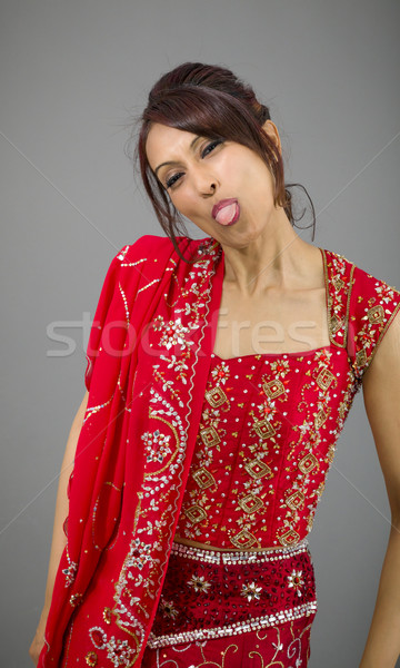 Young Indian woman sticking out her tongue Stock photo © bmonteny