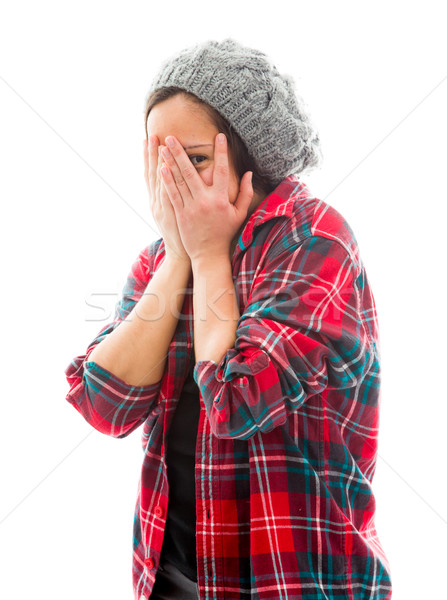 Young woman peeking through hands covering face Stock photo © bmonteny