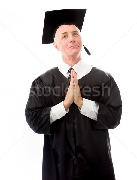 Senior male graduate holding hands together and praying Stock photo © bmonteny