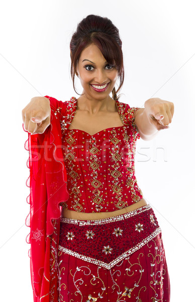 Smiling young Indian woman pointing towards camera from both hands Stock photo © bmonteny