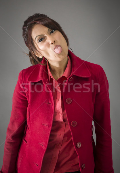 Indian young woman sticking out her tongue Stock photo © bmonteny