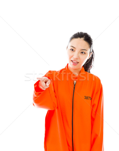 Young Asian woman showing something in prisoners uniform Stock photo © bmonteny