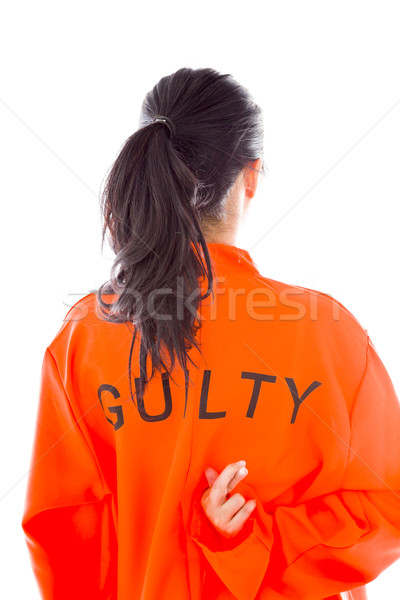Rear view of a young Asian woman in prisoners uniform standing with finger crossed Stock photo © bmonteny