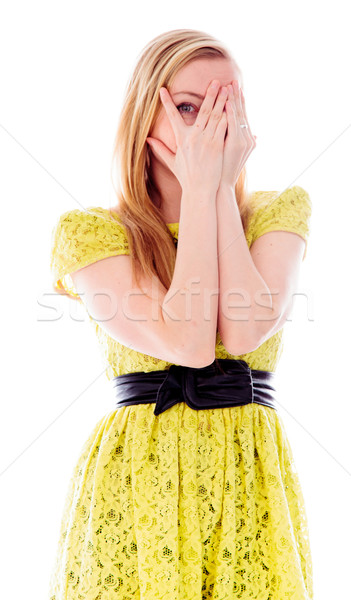 Young woman peeking through hands covering face Stock photo © bmonteny