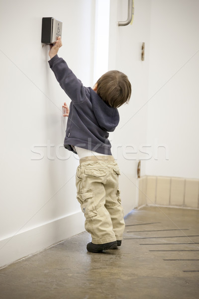 Boy using a card key to open a door Stock photo © bmonteny