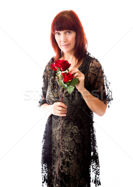 Mature woman holding red rose Stock photo © bmonteny