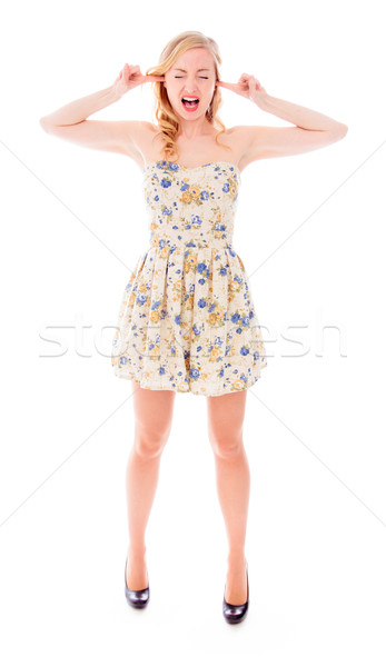 Young woman standing with fingers in her ears Stock photo © bmonteny