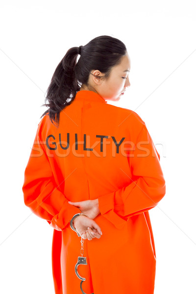 Rear view of a handcuffed Asian young woman in prisoners uniform Stock photo © bmonteny