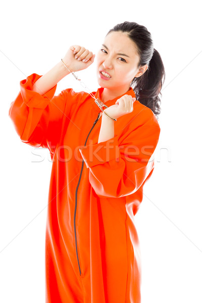 Frustrated handcuffed Asian young woman in prisoners uniform Stock photo © bmonteny