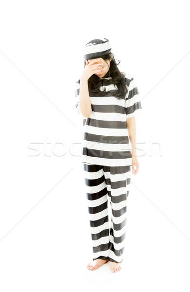 Upset young Asian woman with her head in hands in prisoners uniform Stock photo © bmonteny