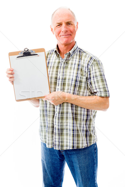 Stock photo: Senior man showing a clipboard